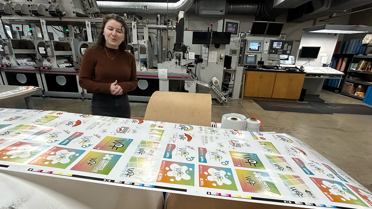 Kathryn Taylor, project coordinator at the Sonoco Institute, shows off Women of Flexo stickers made by student interns.