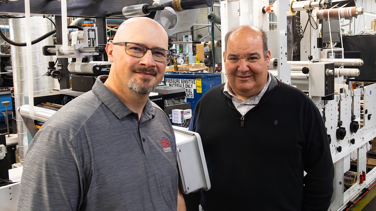 L-R: Ryan Zins, RFID manager at DLS and Mike Kaufman, vice president of manufacturing at DLS in front of the new Mark Andy servo die-cutter.