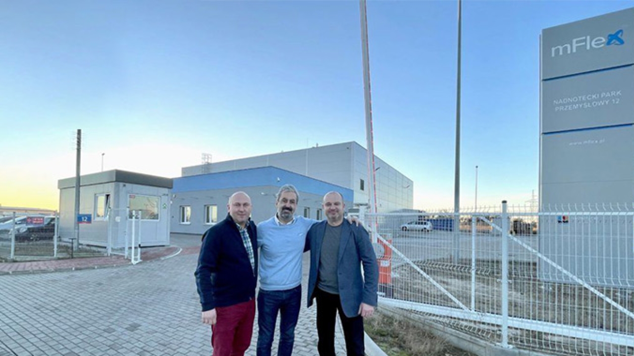 L-R - Marcin Kowalski, Johnny Hobeika, and Jacek Ciosek in front of mFlex headquarters in Poland. L-R - Marcin Kowalski, Johnny Hobeika, and Jacek Ciosek in front of mFlex headquarters in Poland.